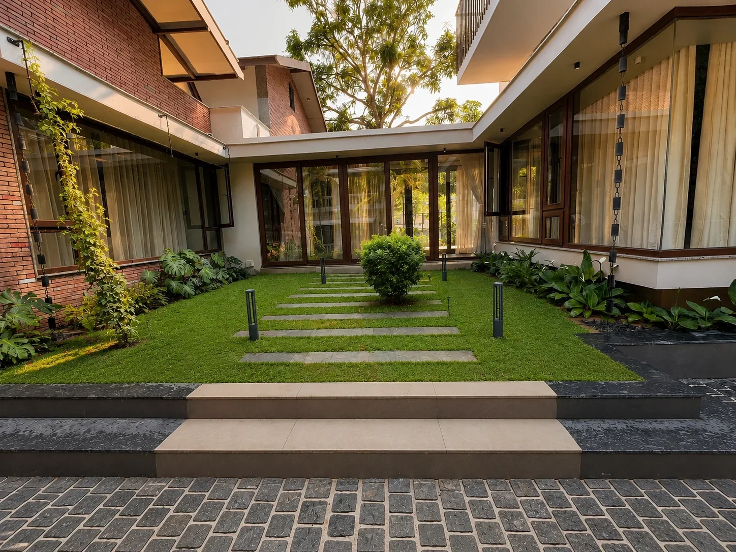 Private courtyard garden with lawn, steps and glass facade