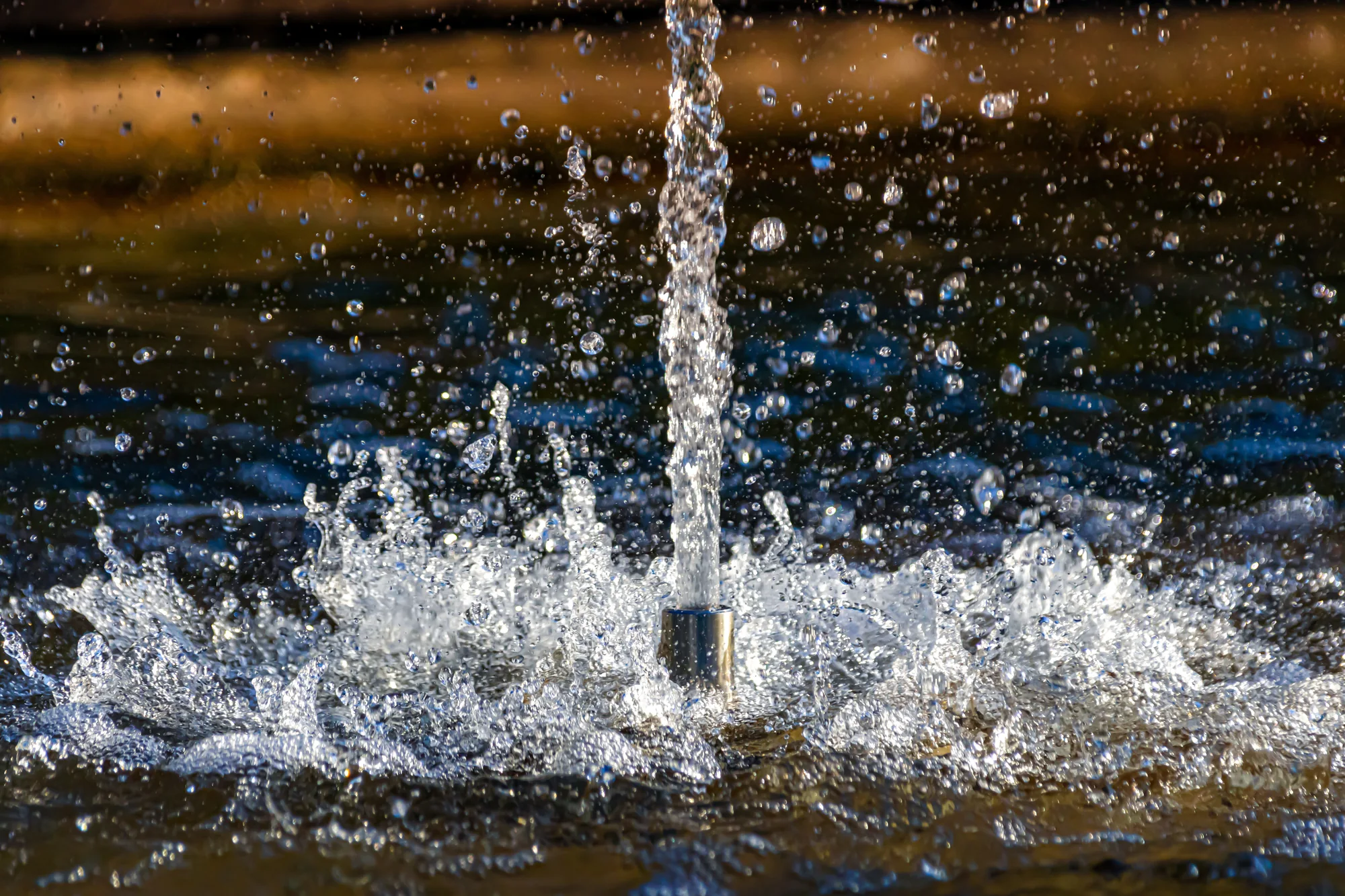 Close-up of a fountain jet freezing droplets in mid-air